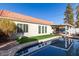 Beautiful backyard pool with tile roof, outdoor seating under pergola, manicured lawn, and privacy fence at 1201 E Campbell Ave, Gilbert, AZ 85234