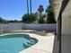 Backyard featuring a sparkling in-ground pool with white fencing and lush desert landscaping at 1309 E Julie Dr, Tempe, AZ 85283