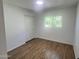 Bedroom featuring wood-look flooring, bright natural light, and ample closet space at 1309 E Julie Dr, Tempe, AZ 85283