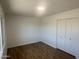 Well-lit bedroom features wood-look flooring and a closet with sliding doors at 1309 E Julie Dr, Tempe, AZ 85283