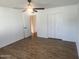 Bright bedroom with ceiling fan, wood-look floors, and closet for ample storage at 1309 E Julie Dr, Tempe, AZ 85283