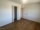 Spacious bedroom with closet, wood flooring and entry to adjacent room at 1309 E Julie Dr, Tempe, AZ 85283