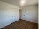 Spacious bedroom featuring wood-look flooring and a closet with traditional doors at 1309 E Julie Dr, Tempe, AZ 85283
