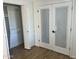 Bright bedroom features a closet and stylish glass doors with blinds at 1309 E Julie Dr, Tempe, AZ 85283