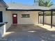 A spacious carport featuring a painted cement floor, a rear entrance, and a window at 1309 E Julie Dr, Tempe, AZ 85283