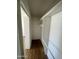 Walk-in closet featuring built-in shelving and wood-look floors at 1309 E Julie Dr, Tempe, AZ 85283