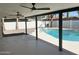 Large covered patio with dual ceiling fans and views of the sparkling backyard pool and desert landscaping at 1309 E Julie Dr, Tempe, AZ 85283