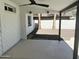Covered patio with ceiling fan and view of the landscaped yard with mature trees and white fencing at 1309 E Julie Dr, Tempe, AZ 85283