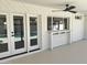 Spacious covered patio with a built-in bar area, ceiling fan, and views of the pool through patio doors at 1309 E Julie Dr, Tempe, AZ 85283