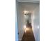 Hallway with wood-look flooring and white walls, bright overhead light fixture at 1309 E Julie Dr, Tempe, AZ 85283