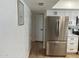 Hallway adjacent to kitchen with stainless refrigerator and white cabinets at 1309 E Julie Dr, Tempe, AZ 85283