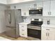 Modern kitchen features stainless appliances, white cabinets and quartz countertops at 1309 E Julie Dr, Tempe, AZ 85283