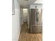 Bright kitchen showcasing a stainless steel refrigerator, white cabinets and wood-look flooring at 1309 E Julie Dr, Tempe, AZ 85283