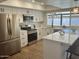 Kitchen boasts stainless appliances, white cabinets, and quartz countertops with views of the pool at 1309 E Julie Dr, Tempe, AZ 85283