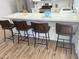 Kitchen island with barstool seating, quartz countertops and stainless steel appliances at 1309 E Julie Dr, Tempe, AZ 85283