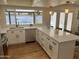 Modern white kitchen featuring stainless appliances, pendant lights, and counter seating area at 1309 E Julie Dr, Tempe, AZ 85283