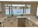 Kitchen sink and quartz countertops with a view of the backyard pool at 1309 E Julie Dr, Tempe, AZ 85283
