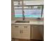 Kitchen sink and quartz countertops with a view of the sparkling backyard pool at 1309 E Julie Dr, Tempe, AZ 85283