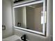 Close-up of an illuminated bathroom mirror with touch controls, enhancing the modern aesthetic of the vanity area at 1309 E Julie Dr, Tempe, AZ 85283
