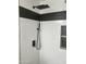 Modern shower featuring black fixtures, white tile, and a built-in shelf for a minimalist and sleek design at 1309 E Julie Dr, Tempe, AZ 85283