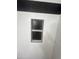 Close up detail of a built in shower shelf with a black honeycomb insert at 1309 E Julie Dr, Tempe, AZ 85283