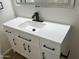 Close-up on vanity featuring white countertops, sleek black hardware, and a modern black faucet for a stylish look at 1309 E Julie Dr, Tempe, AZ 85283