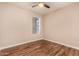 Bright bedroom featuring sleek wood floors, a window that provides natural light, and a ceiling fan at 1331 W Baseline Rd # 167, Mesa, AZ 85202