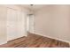 Bedroom showing wood floors and closet with sliding doors and entry door at 1331 W Baseline Rd # 167, Mesa, AZ 85202