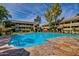 Community pool featuring clear blue water, stone pool deck, lounge chairs, and surrounding multi-story buildings at 1331 W Baseline Rd # 167, Mesa, AZ 85202