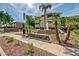 Well-maintained condo community entrance featuring a fountain, lush landscaping, and mature palm trees at 1331 W Baseline Rd # 167, Mesa, AZ 85202