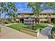 Inviting two-story condo featuring landscaped grounds with mature trees and outdoor seating at 1331 W Baseline Rd # 167, Mesa, AZ 85202