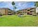 Community common area is featuring lush green landscaping, walking paths, fountain and community buildings at 1331 W Baseline Rd # 167, Mesa, AZ 85202
