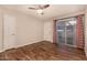 Inviting living room with wood-style flooring, ceiling fan, and a large sliding glass door, bringing in natural light at 1331 W Baseline Rd # 167, Mesa, AZ 85202