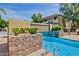 Close up of the serene community pool showcasing a tranquil waterfall and lush landscaping at 1331 W Baseline Rd # 167, Mesa, AZ 85202