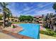 A community pool is surrounded by lush landscaping, comfortable seating, and inviting blue water at 1331 W Baseline Rd # 167, Mesa, AZ 85202