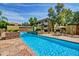 A serene community pool features a tranquil waterfall, comfortable seating, and lush landscaping for relaxation at 1331 W Baseline Rd # 167, Mesa, AZ 85202