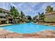 A tranquil community pool with lush landscaping, serene waterfalls, and comfortable lounge chairs for relaxation at 1331 W Baseline Rd # 167, Mesa, AZ 85202