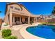 Backyard featuring a pool, turfed lawn, desert landscaping and patio at 15229 S 18Th Dr, Phoenix, AZ 85045