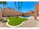 Backyard featuring a pool, turfed lawn, and manicured landscaping at 15229 S 18Th Dr, Phoenix, AZ 85045