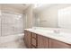 Bright bathroom with a double sink vanity, and a shower and tub combo at 15229 S 18Th Dr, Phoenix, AZ 85045