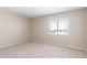 Neutral bedroom showcasing a window with blinds allowing natural light to filter in at 15229 S 18Th Dr, Phoenix, AZ 85045
