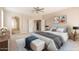 Tranquil main bedroom with ensuite bathroom, neutral tones, and ceiling fan at 15229 S 18Th Dr, Phoenix, AZ 85045