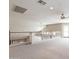 Upper level bonus room with ceiling fan, carpet, stairs to lower level, and white railing at 15229 S 18Th Dr, Phoenix, AZ 85045