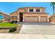 Charming two-story home with a three car garage, a manicured lawn and desert landscaping at 15229 S 18Th Dr, Phoenix, AZ 85045