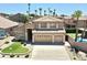 Charming two-story home featuring a three-car garage, desert landscaping, and mature palm trees at 15229 S 18Th Dr, Phoenix, AZ 85045
