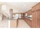 Bright kitchen with a large island, tile floors, modern appliances, and convenient access to the staircase at 15229 S 18Th Dr, Phoenix, AZ 85045