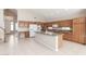 Well-equipped kitchen with an island, modern appliances, wooden cabinets, and tile flooring at 15229 S 18Th Dr, Phoenix, AZ 85045