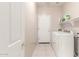 Well-lit laundry room featuring a modern washer and dryer and ample storage shelves at 15229 S 18Th Dr, Phoenix, AZ 85045