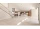 Bright and airy living space featuring tile flooring, a staircase, and a view of the modern kitchen at 15229 S 18Th Dr, Phoenix, AZ 85045