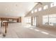Open-concept living room with a kitchen, tile flooring, high ceilings, and sliding glass doors to the patio at 15229 S 18Th Dr, Phoenix, AZ 85045